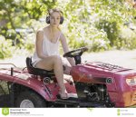 young-woman-driving-ride-mower-as-cuts-lawn-garden-wearing-ear-muffs-to-reduce-sound-motor-41477.jpg