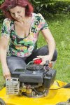 14015928-smilling-women-oiling-lawn-mover-during-mowing-the-grass.jpg