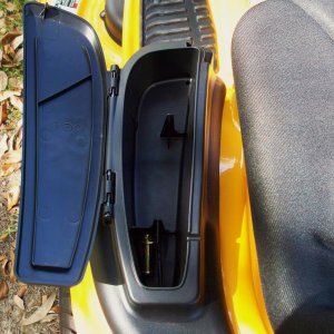 storage compartment with MP3 player holder & earbud wire cut through
