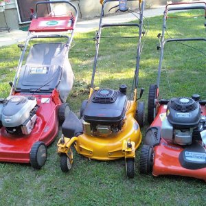 Nice set of machines. That's the Husqvarna that had the broken wheel bracket on the right. The Scotts machine on the left had a real cool primer butto