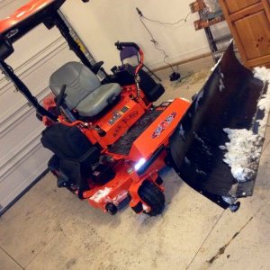Here is the reason for all the lights, and reflectors!
It's the Mibar electric snow plow. 
Had wider sidewalks put in so I can plow both the drive and