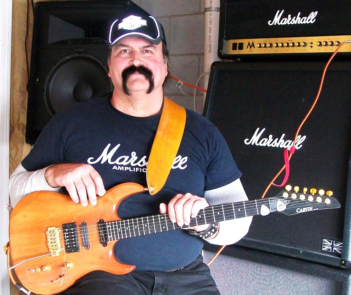 100 0486(1)  Carvin DC135, all mahogany neck-thru, modded with Seymour Duncan: Hot,Cool Rails and Pearly Gates.  Headstock is autographed by Peter Tor