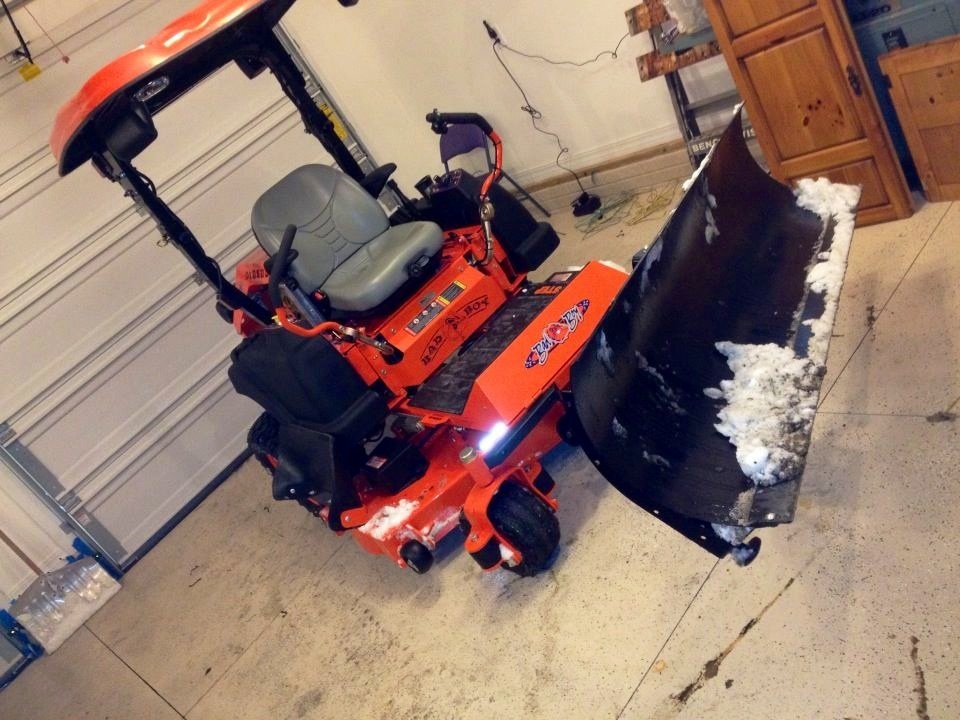 Here is the reason for all the lights, and reflectors!
It's the Mibar electric snow plow. 
Had wider sidewalks put in so I can plow both the drive and